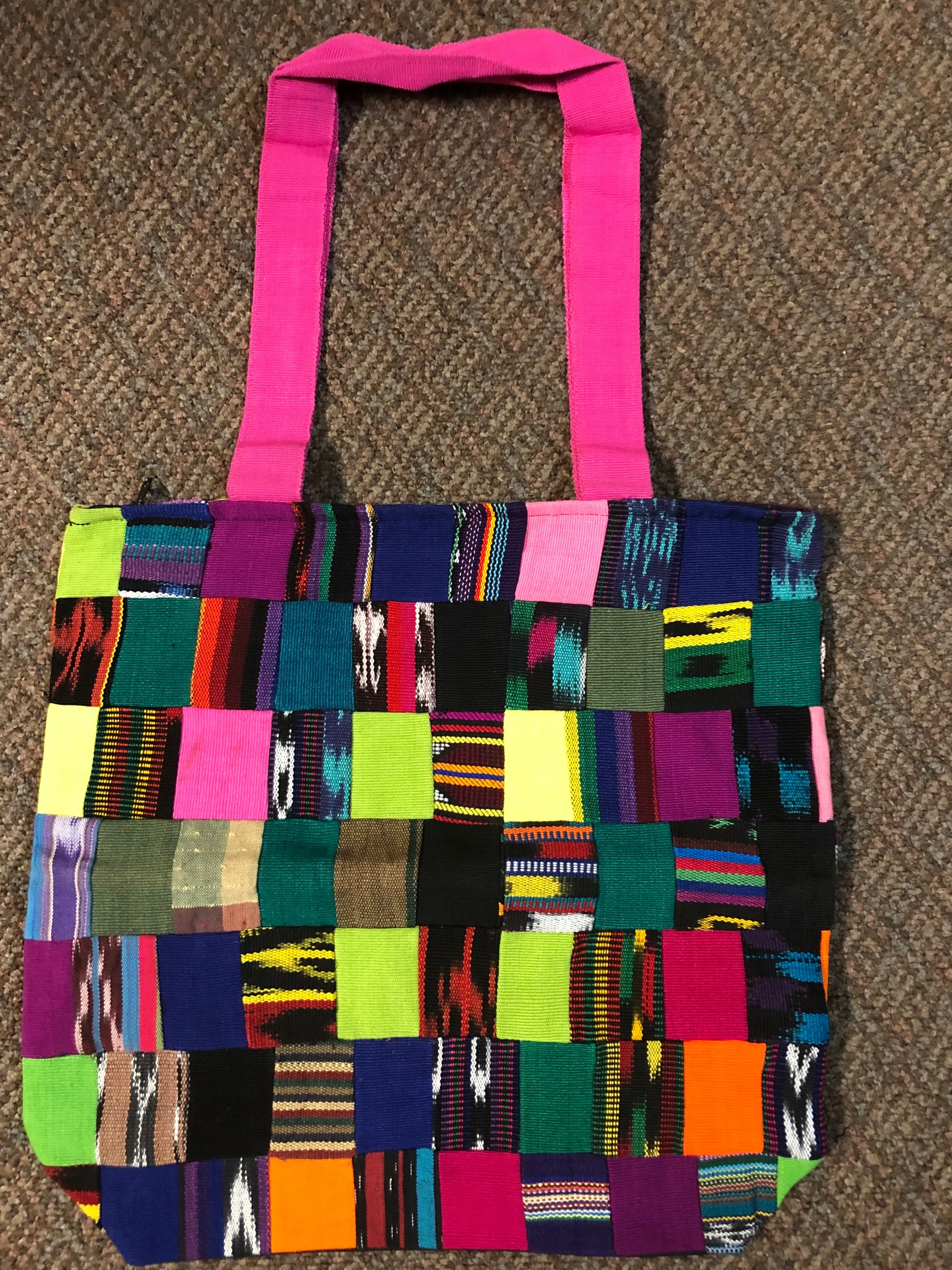 Handwoven Guatemalan cotton patches fashioned into a sturdy shoulder bag, fully lined with one zipper pocket. 15” x 17”