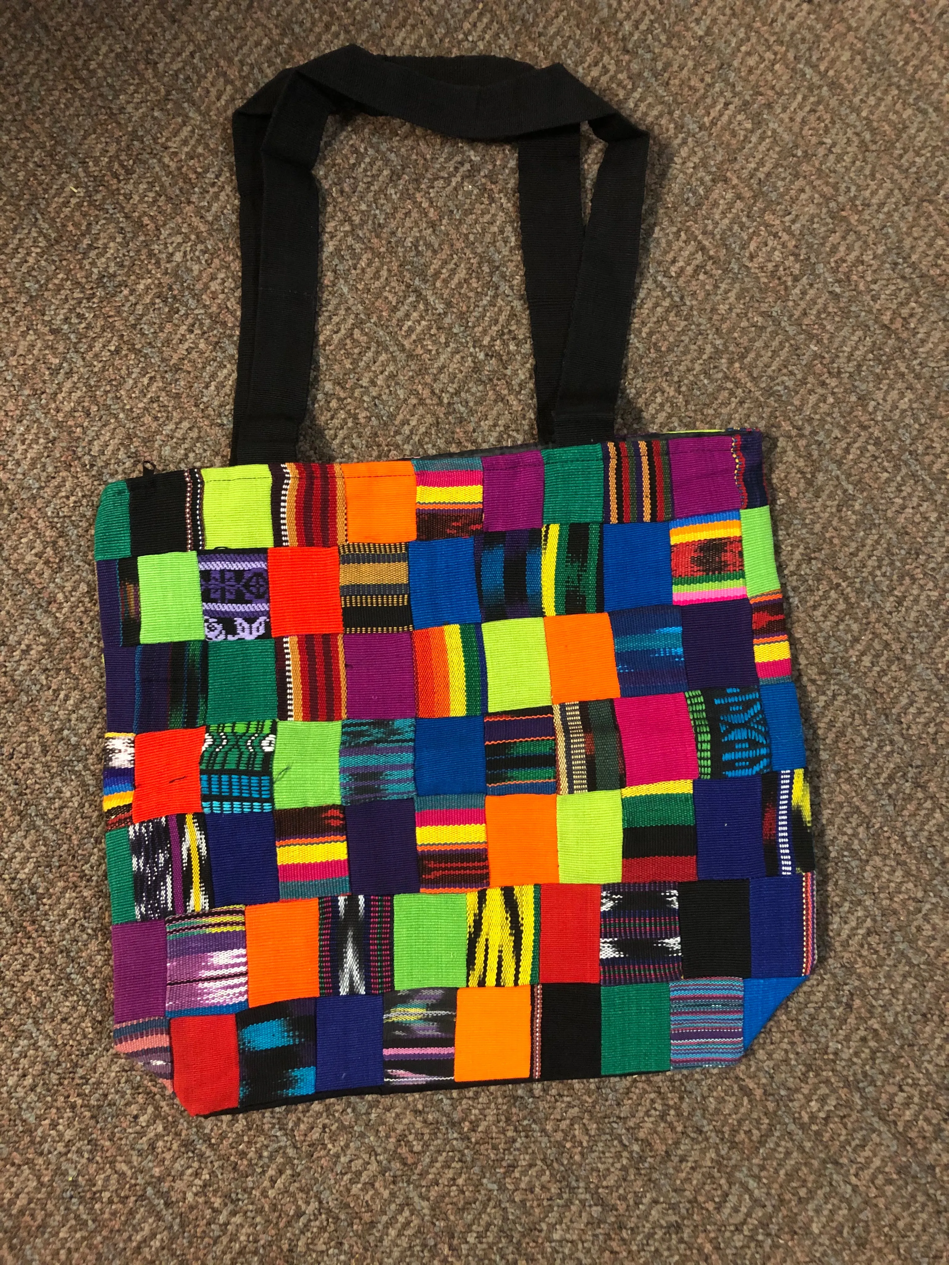 Handwoven Guatemalan cotton patches fashioned into a sturdy shoulder bag, fully lined with one zipper pocket. 15” x 17”